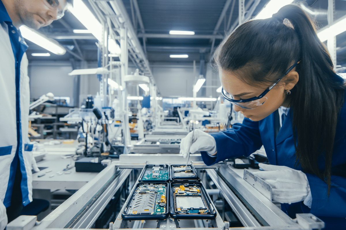 woman assembling tech parts