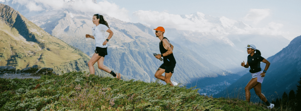 Three people trail running through an alpine mountain trail