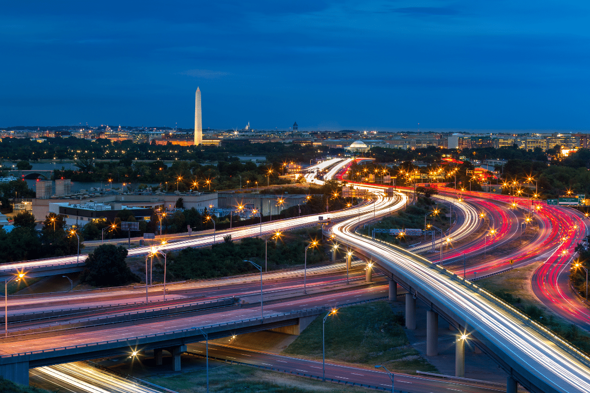 Washington, D.C. cityscape at dusk with light trails from highway traffic